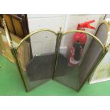 A four panel brass folding firescreen and a small fireback