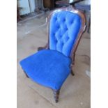 A Victorian button back chair on turned legs