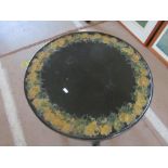 A brass top table on folding base, painted black with decoupage border