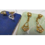 A pair of gold coloured earrings set white stones and another pair earrings