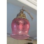 A cranberry glass ceiling light with metal top
