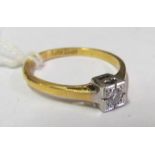 An 18ct gold and platinum ring set diamond in square illusion setting, size N/O 2.5g