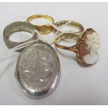 A cameo ring, three rings and a silver locket