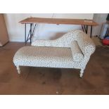 A small chaise longue painted white