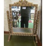 A gilt swing toilet mirror