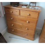 A modern pine chest two short and three long drawers