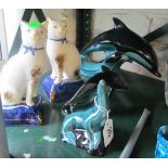 Two Poole Pottery dolphins (one a/f), a Poole Pottery seal and two Staffordshire cats (one a/f)
