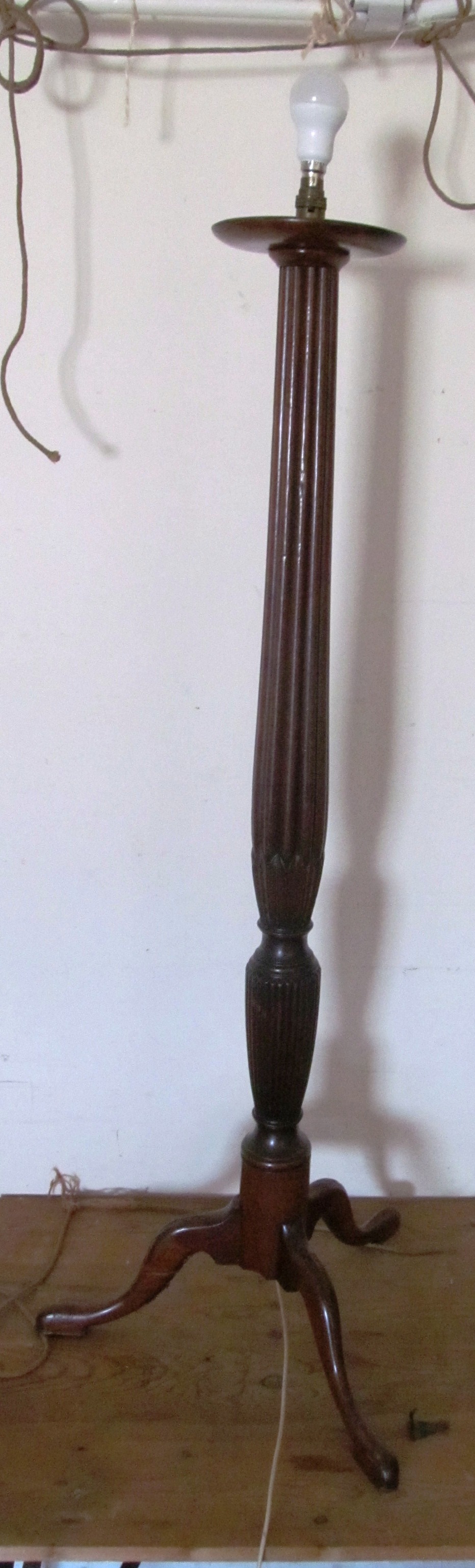 A mahogany standard lamp with fluted column