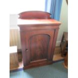 A mahogany cabinet with galley and panelled door