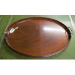 An oval mahogany two handled tray