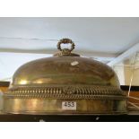 A large silver-plated food cover with gadrooned and shell pattern border