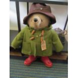 A Paddington Bear in green jacket