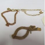 A rose gold chain attached to another chain, two gold coloured bracelets, a copper bangle and some