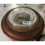 An aneroid barometer (glass a/f) and another