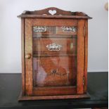 An oak smoker's cabinet glazed door and drawers