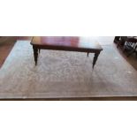 A light grey large rug with classical floral design