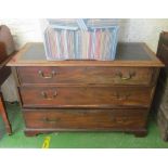 A mahogany chest of three long drawers leatherette top