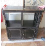 An Edwardian ebonized cabinet