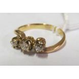 A gold three stone diamond ring, size I 2g