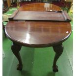 A Victorian extending mahogany dining table on carved cabriole legs with extra leaf and handle