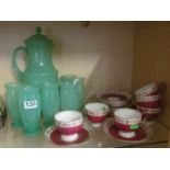 A green glass lemonade set and a red and gilt teaset