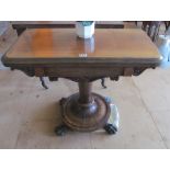 A 19th Century rosewood card table on pillar and circular base and claw feet