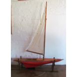 A large pond yacht with single sail on stand approximately 81" long