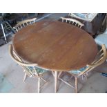 An Ercol dropleaf dining table on tapered supports