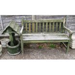 A wooden garden bench and a wishing well