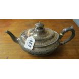 An oval silver teapot
