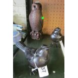 A resin model of an owl and two bird ornaments