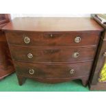 A late 19th Century mahogany bowfront chest of three long drawers, replacement gilt circular