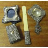 A silver frame, sifter, matchbox cover and paperknife