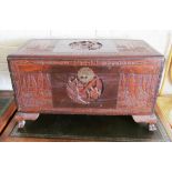 An oriental camphorwood blanket chest carved scenes of sailing boats and figures in landscapes
