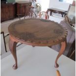 A carved eastern circular occasional table on cabriole legs