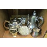 A silver plated teapot, coffee pot and a small group of plated items and cutlery
