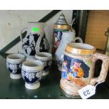 Two German beer steins, a wine set jug and three cups and another jug