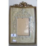 A photo frame with cresting of trumpet and flowers and jewelled inner frame