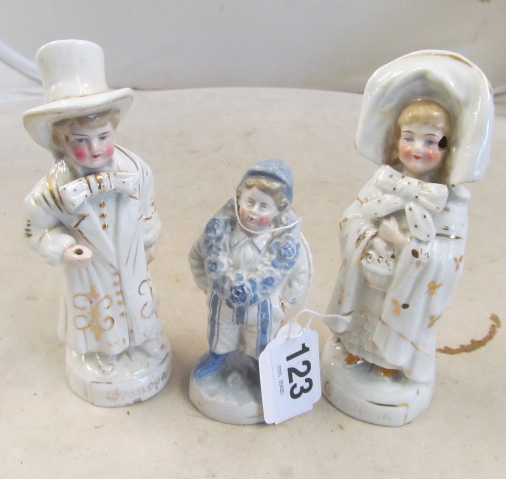 A Victorian pottery figure of a jockey with garland flowers round his neck, a pair of Victorian