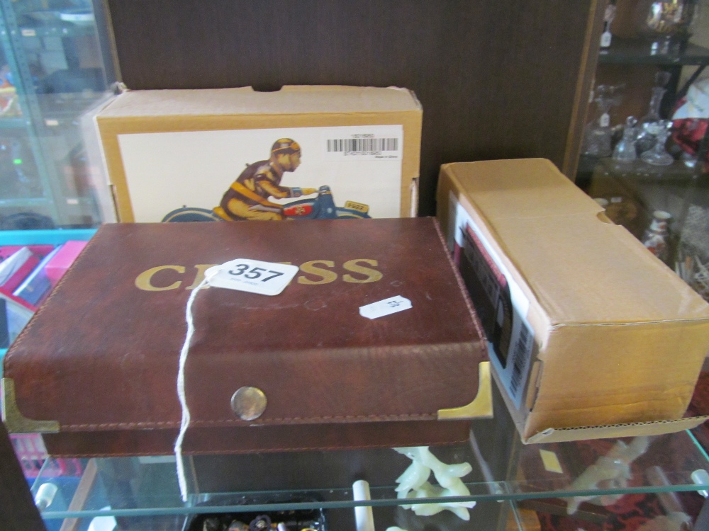 A modern tinplate motorcycle rider, a vintage bus (both boxed) and modern chess set