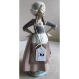 A Lladro figure Dutch girl with hands on hips