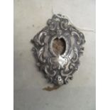 A continental silver coloured reliquary holder embossed cherub