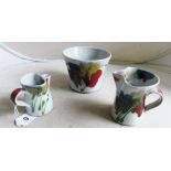 Janice Tchelenko - a Dart pottery plant pot and two jugs with floral decoration