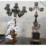 A porcelain five branch candelabra lady with sheep and a modern gilt and black candelabra with lion