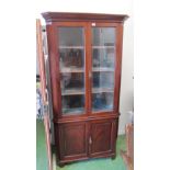 A 19th Century mahogany corner cabinet glazed doors above and cupboards under