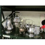 A plated spirit kettle and various teapots and jugs