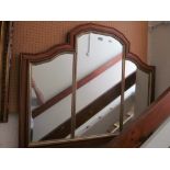 A modern arch top overmantel mirror