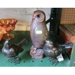 A resin model of an owl and two bird ornaments