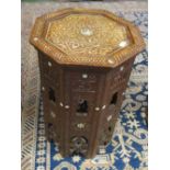 An eastern octagonal inlaid carved coffee table 18.5" high and 13" diameter