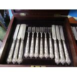 A set of twelve silver fruit knives and forks with embossed handles in fitted box